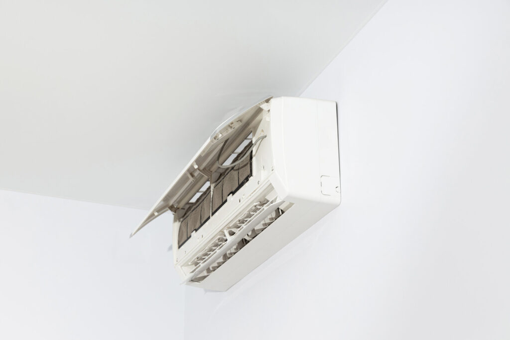 Wall-mounted white air conditioner providing cool air in a modern interior setting.